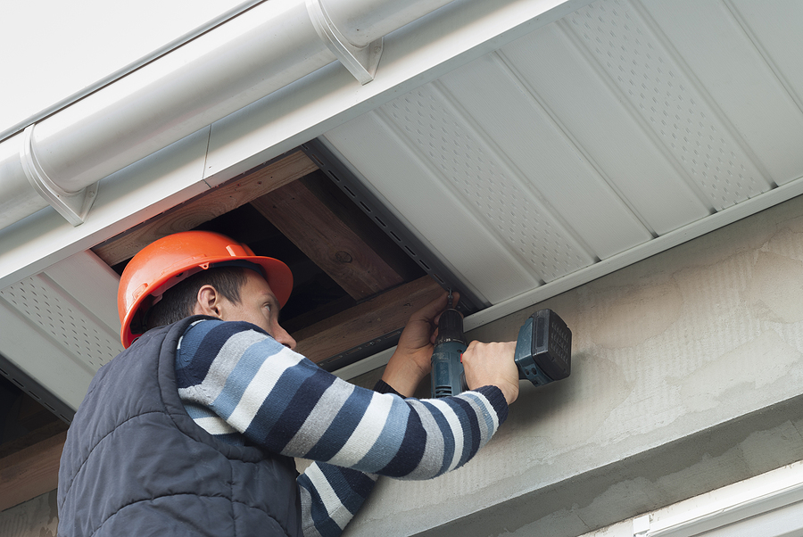 Installation Of Soffits Professionally laid red asphalt shingle rectangular shape on a clean roof